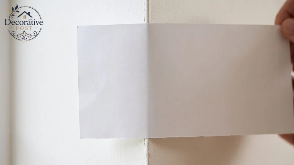 White Dove paint compared against plain white paper to reveal its warm undertone