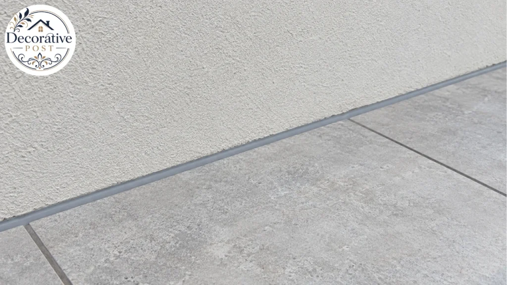 Flexible sealant bead at the perimeter movement joint between porcelain paving and a house wall